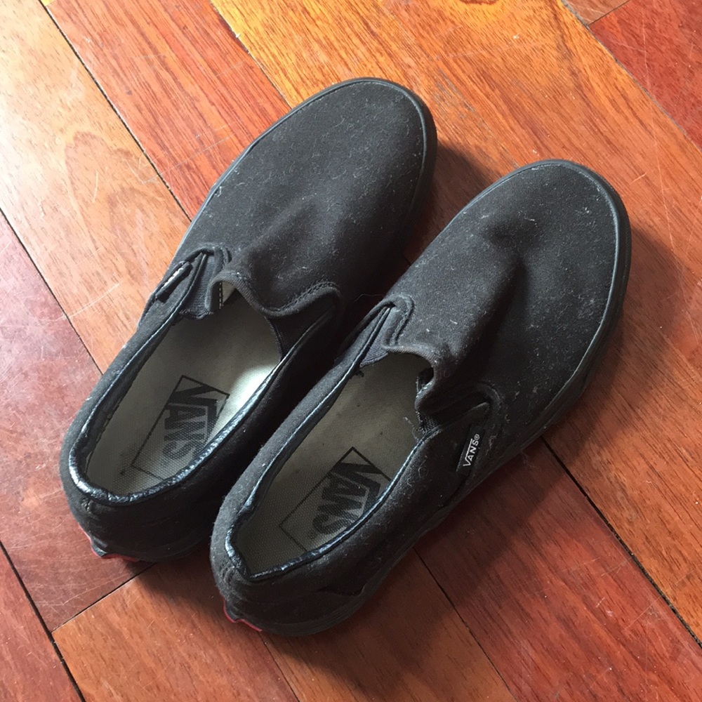 All black Vans slip-on sneakers
